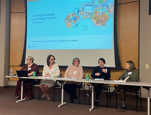 Women presenting while seated