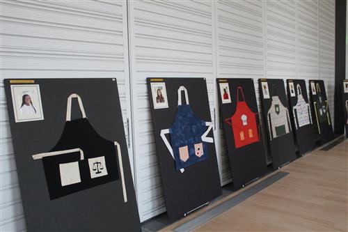 Aprons hung on a board