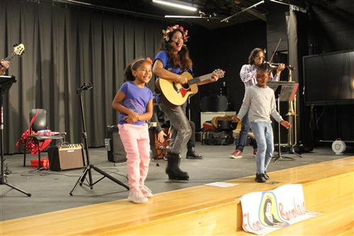 Woman sings with two children