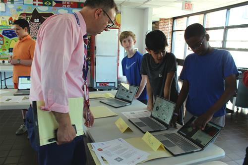 Man speaks with students