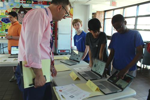 Man speaks with students