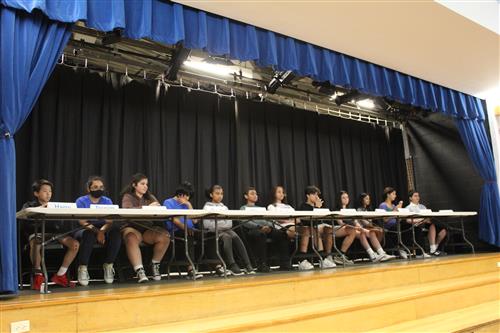 Group of students sitting at one side of table