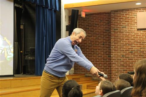 Man with microphone speaking with child