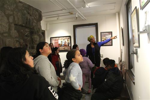 Group of students look at art on wall